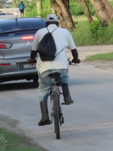 Man on his way to work riding in work boots